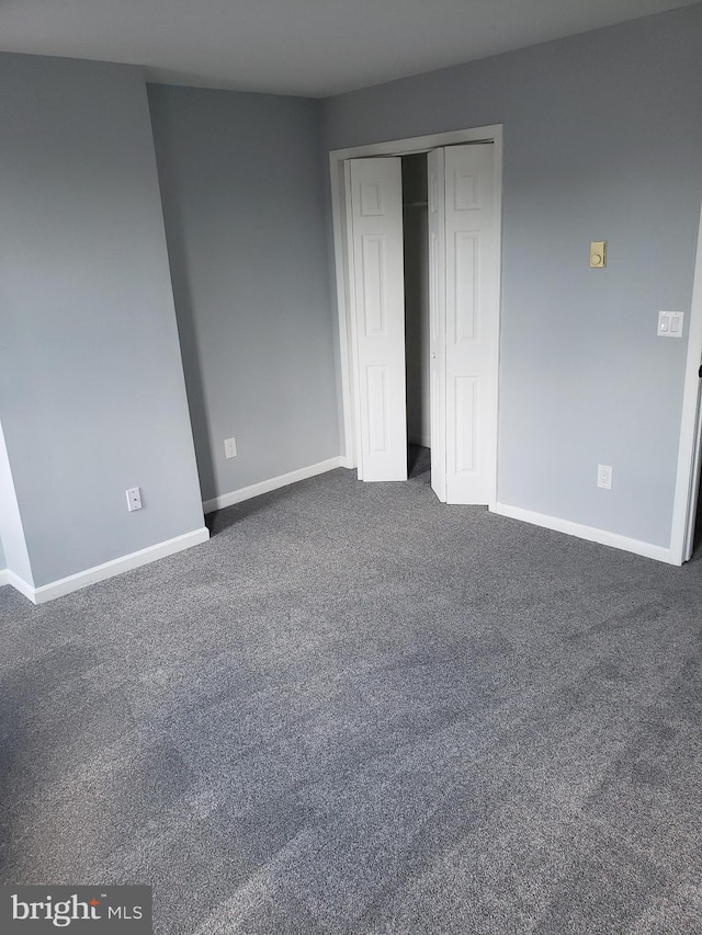 unfurnished bedroom featuring dark colored carpet