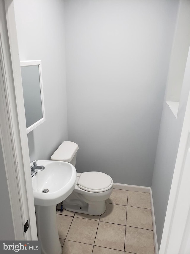 bathroom with tile patterned floors, toilet, and sink