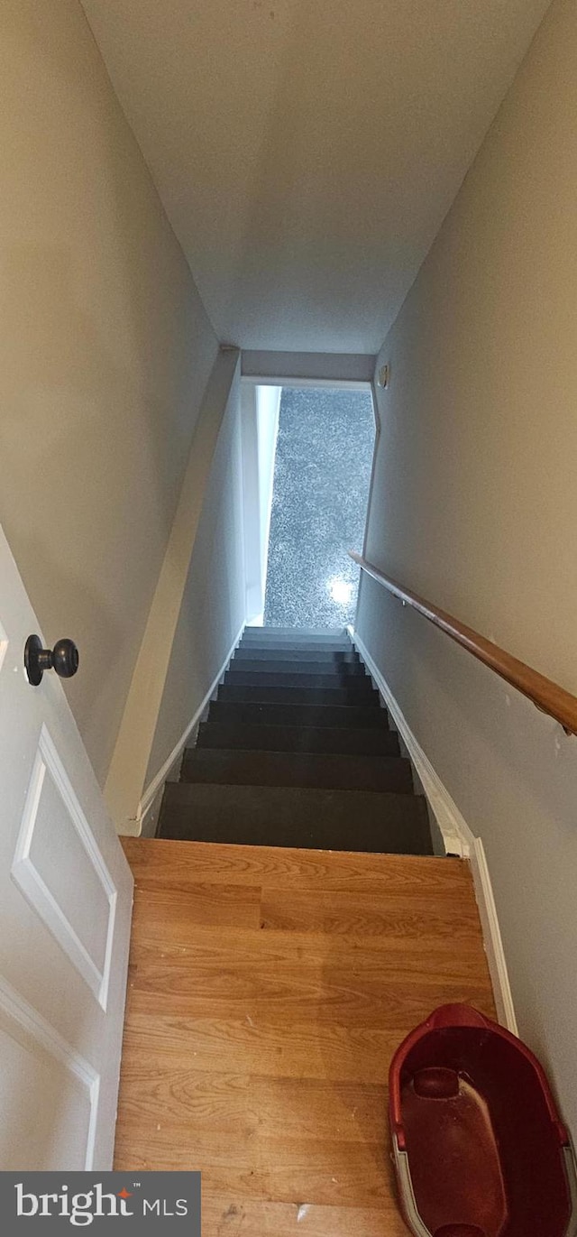 stairway featuring hardwood / wood-style flooring