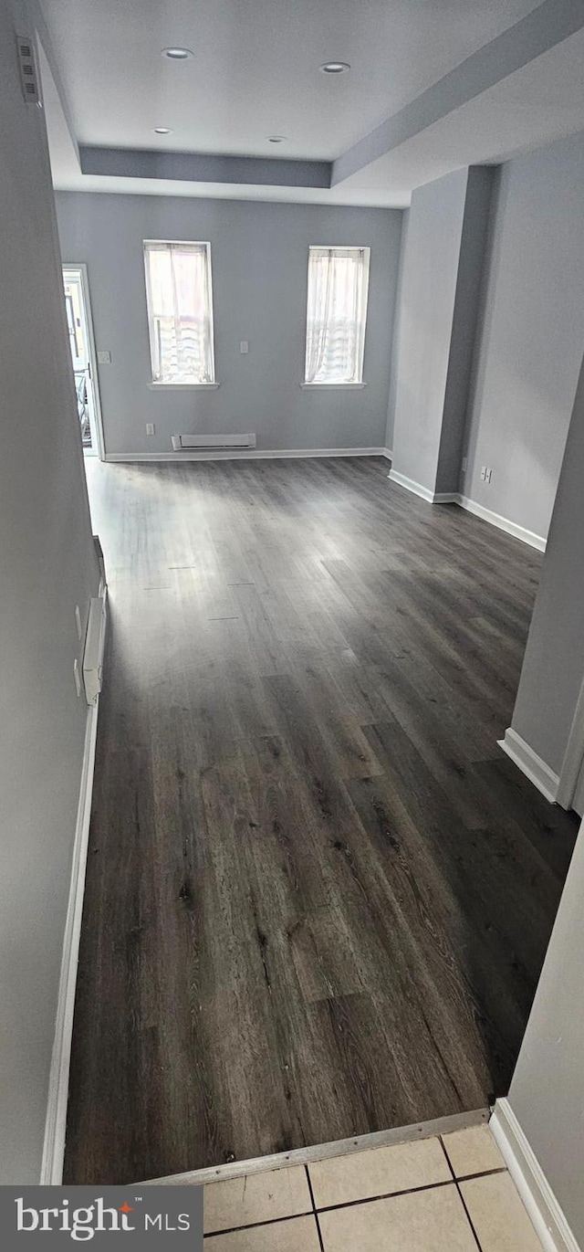 unfurnished room featuring plenty of natural light and hardwood / wood-style flooring