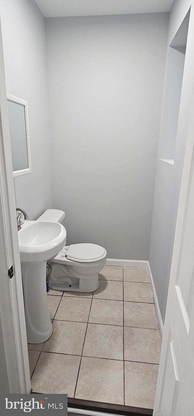 bathroom featuring toilet and tile patterned flooring