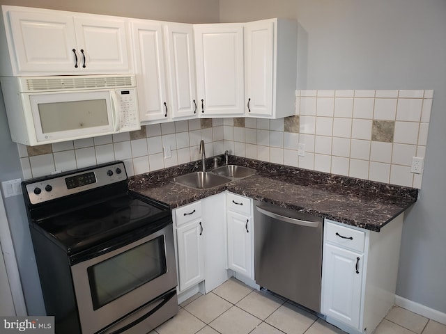 kitchen with white cabinetry, appliances with stainless steel finishes, sink, and tasteful backsplash