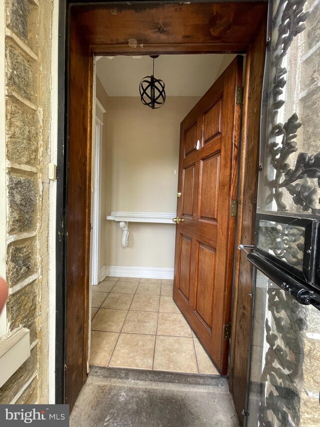 corridor featuring light tile patterned floors