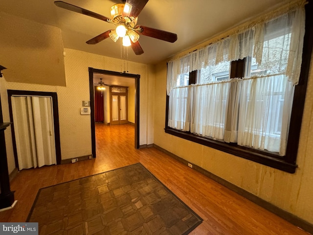 corridor with hardwood / wood-style flooring