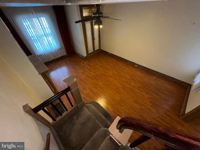 unfurnished living room with hardwood / wood-style flooring and ceiling fan