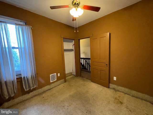 unfurnished bedroom with a closet and ceiling fan