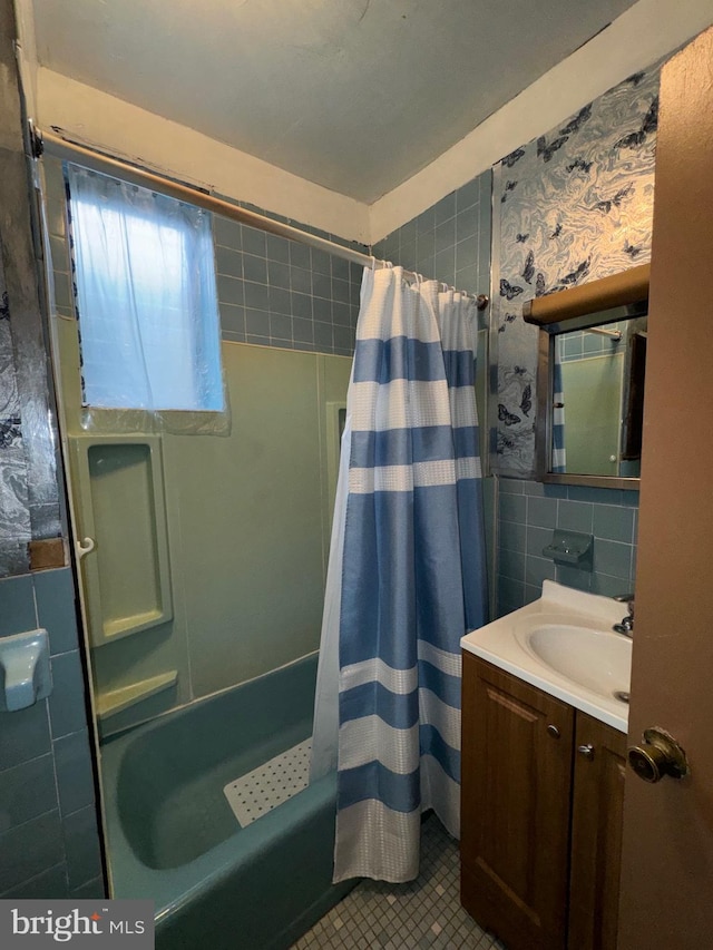 bathroom with vanity, tile walls, shower / bath combo, and tile patterned flooring