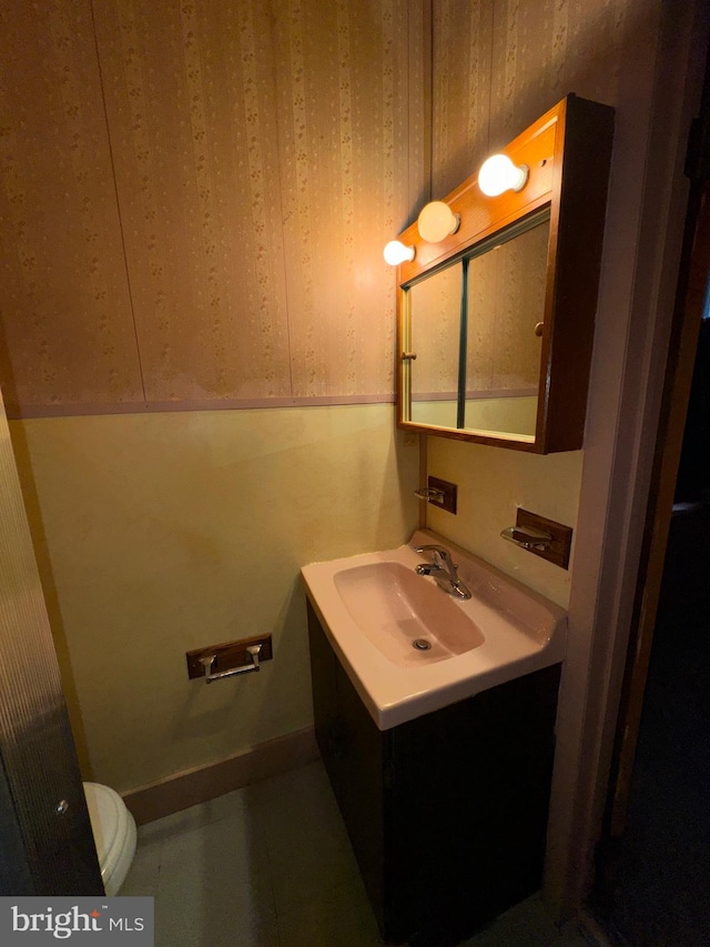 bathroom featuring toilet and vanity