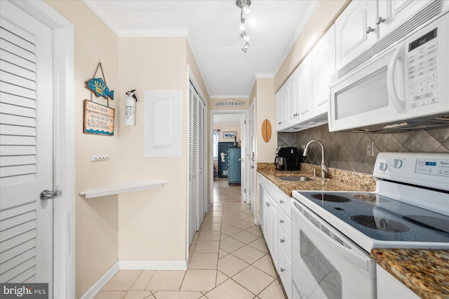 kitchen featuring decorative backsplash, light tile patterned floors, white cabinetry, sink, and white appliances