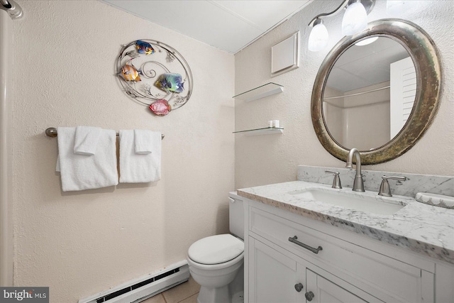 bathroom featuring toilet, a baseboard heating unit, vanity, and tile patterned floors