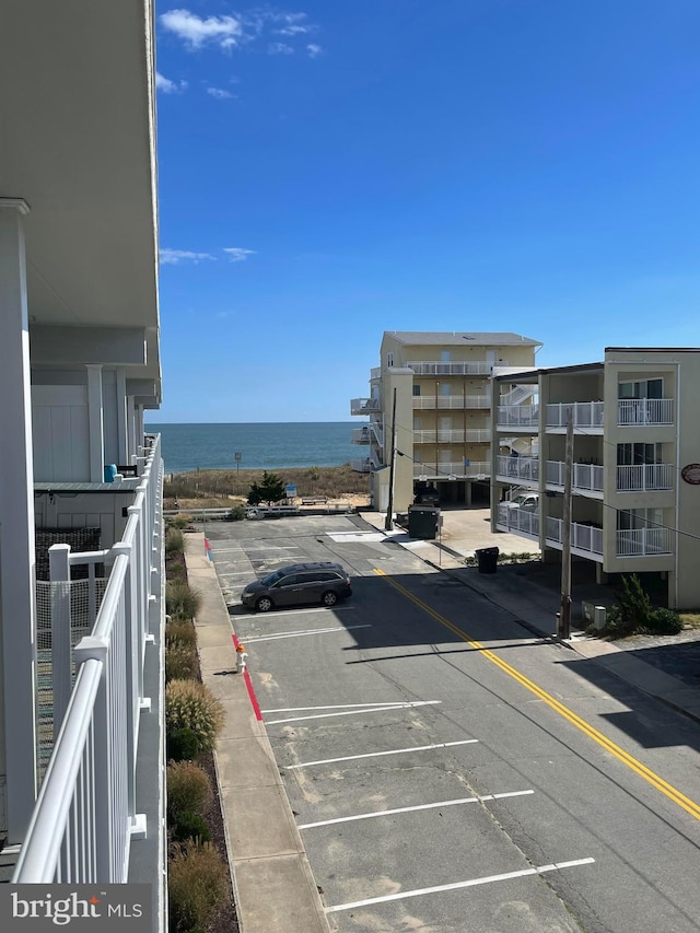 view of car parking with a water view