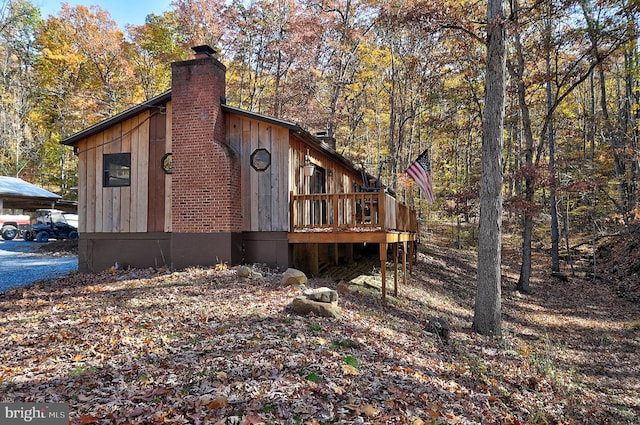 view of side of property featuring a wooden deck