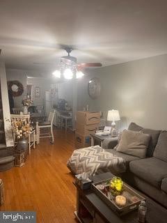 living room featuring ceiling fan and hardwood / wood-style floors