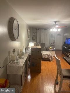 living room featuring wood-type flooring and ceiling fan