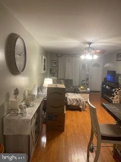 living room with wood-type flooring and ceiling fan