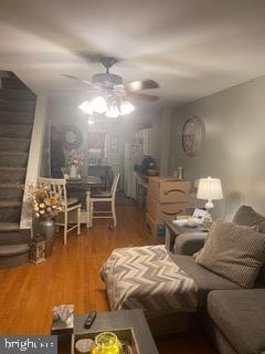 living room with hardwood / wood-style floors and ceiling fan