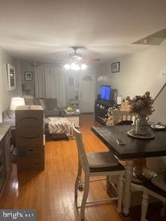 dining space with hardwood / wood-style floors and ceiling fan