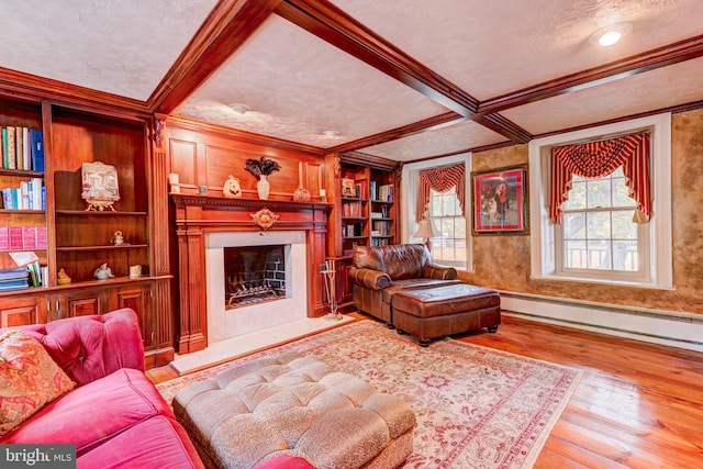 living room featuring crown molding, a textured ceiling, baseboard heating, and light wood-type flooring