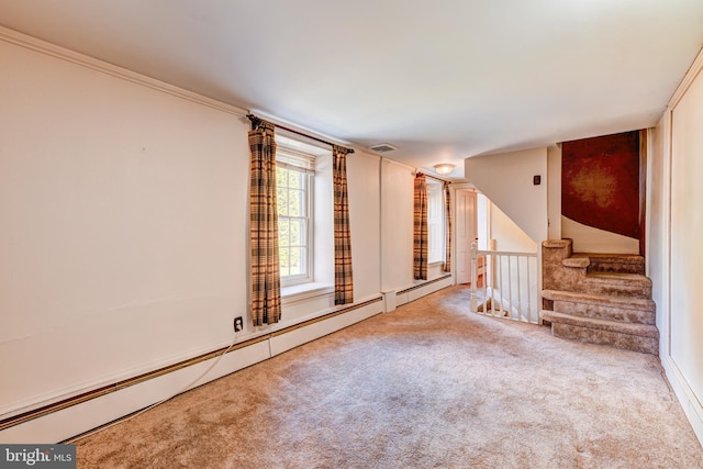 spare room featuring crown molding, carpet flooring, and baseboard heating