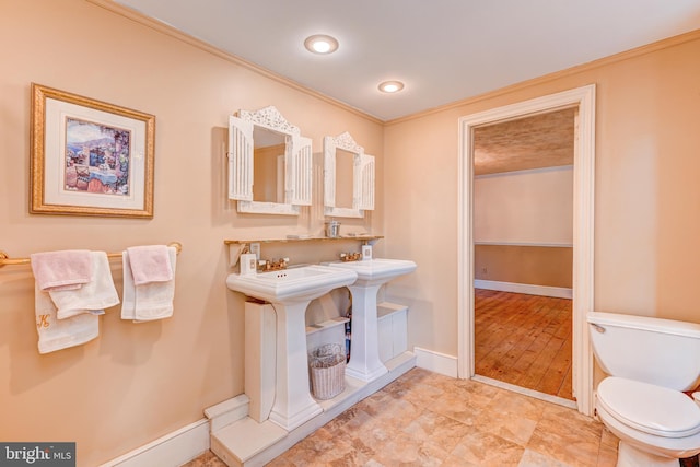 bathroom with toilet, hardwood / wood-style floors, and ornamental molding