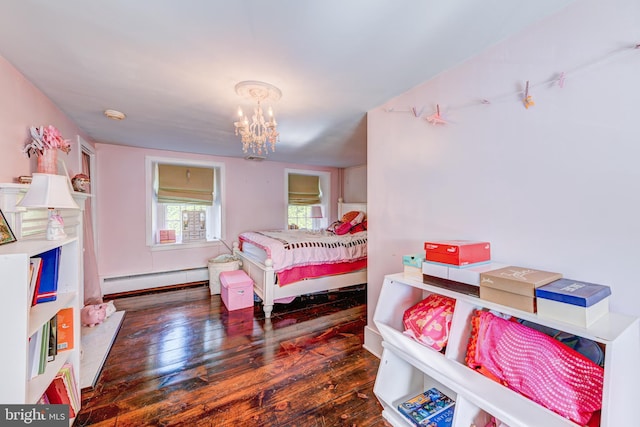 bedroom with an inviting chandelier, a baseboard heating unit, and dark wood-type flooring