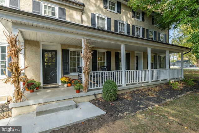 view of exterior entry with a porch