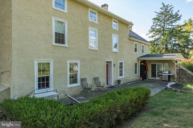 rear view of house featuring a patio