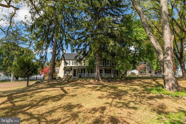 view of front of home with a porch and a front lawn