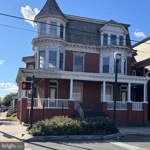 victorian-style house featuring covered porch