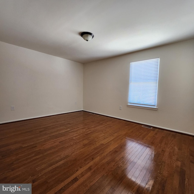 empty room featuring dark wood-type flooring