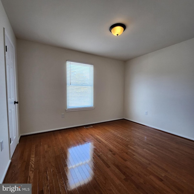 empty room featuring dark hardwood / wood-style flooring