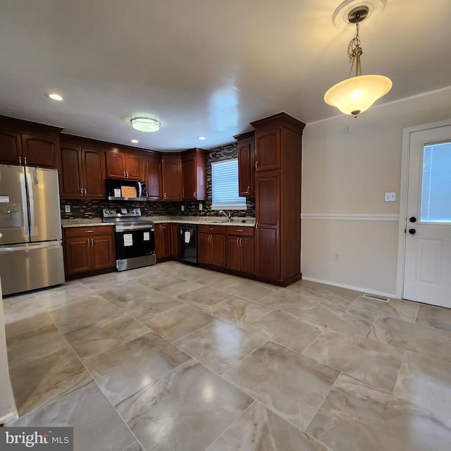 kitchen featuring hanging light fixtures, appliances with stainless steel finishes, plenty of natural light, and tasteful backsplash