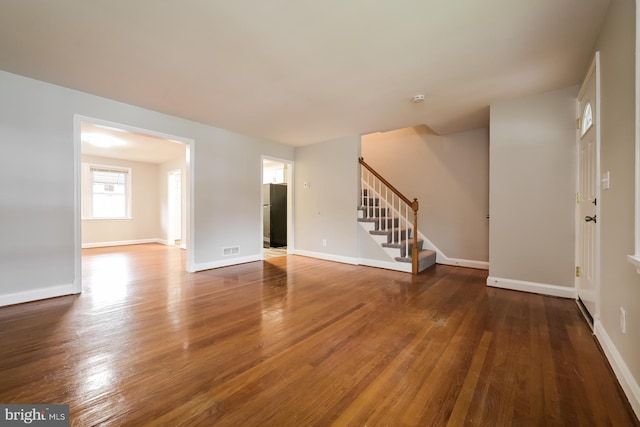 3704 Bonview Ave, Baltimore, MD 21213 - unfurnished living room featuring stairs and wood finished floors