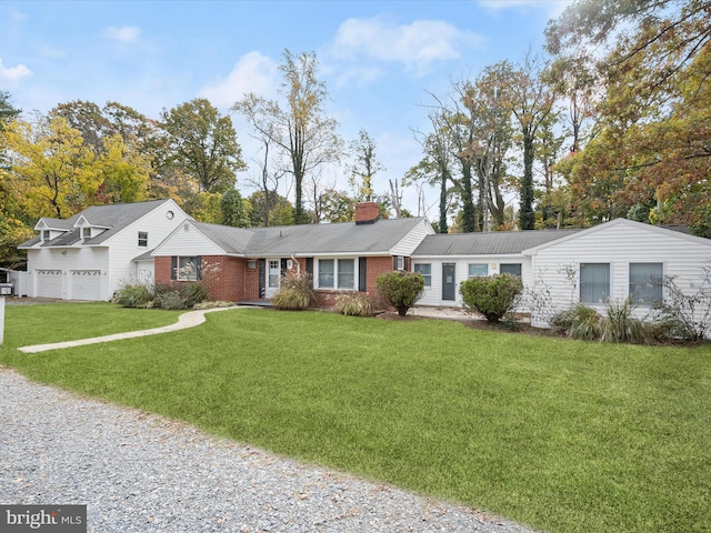ranch-style home with a chimney, gravel driveway, brick siding, and a front lawn
