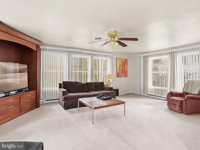 carpeted living room with ornamental molding, a baseboard heating unit, and ceiling fan