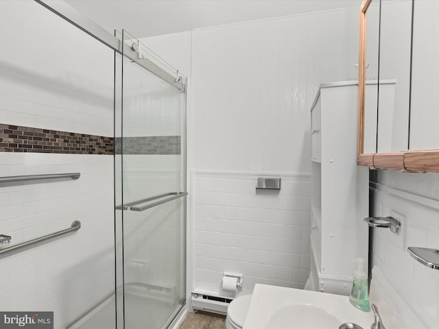 bathroom featuring toilet, walk in shower, a baseboard heating unit, and tile walls