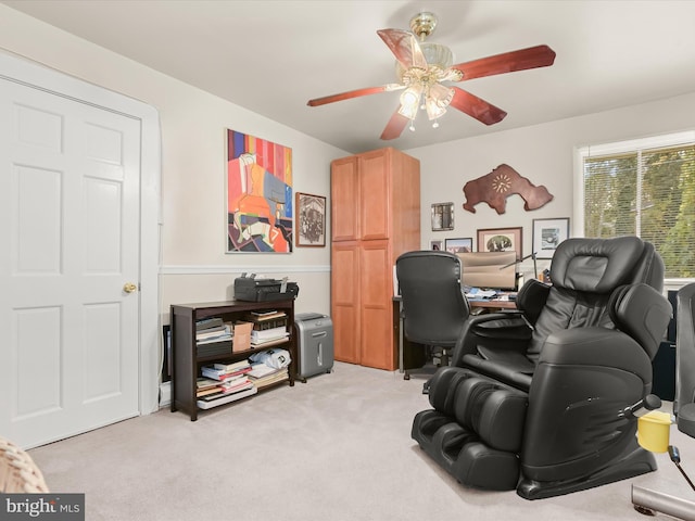 home office featuring light carpet and ceiling fan