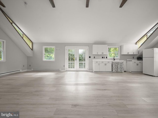 unfurnished living room featuring a baseboard radiator, a sink, light wood finished floors, and plenty of natural light