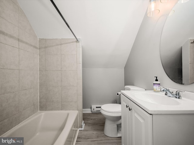 full bathroom featuring lofted ceiling, toilet, wood-type flooring, tiled shower / bath, and vanity