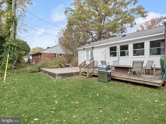 back of property with a yard and a deck