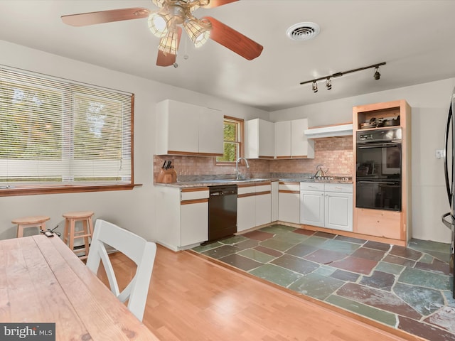 kitchen featuring white cabinets, tasteful backsplash, black appliances, and dark hardwood / wood-style flooring