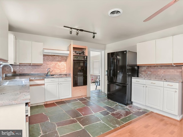 kitchen featuring white cabinets, tasteful backsplash, exhaust hood, black appliances, and sink