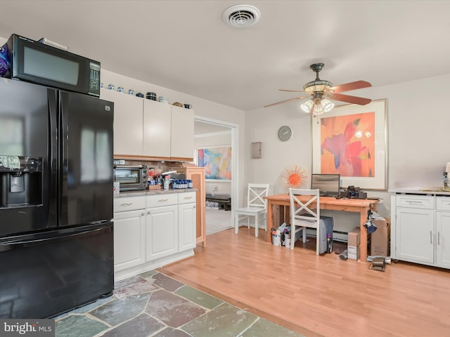 kitchen featuring decorative backsplash, white cabinets, ceiling fan, hardwood / wood-style flooring, and black appliances