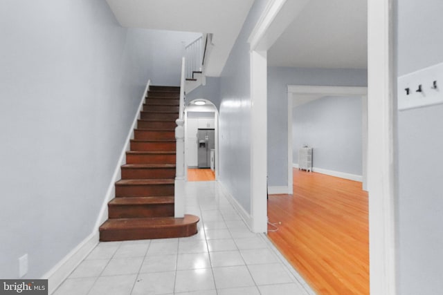 stairway featuring tile patterned flooring