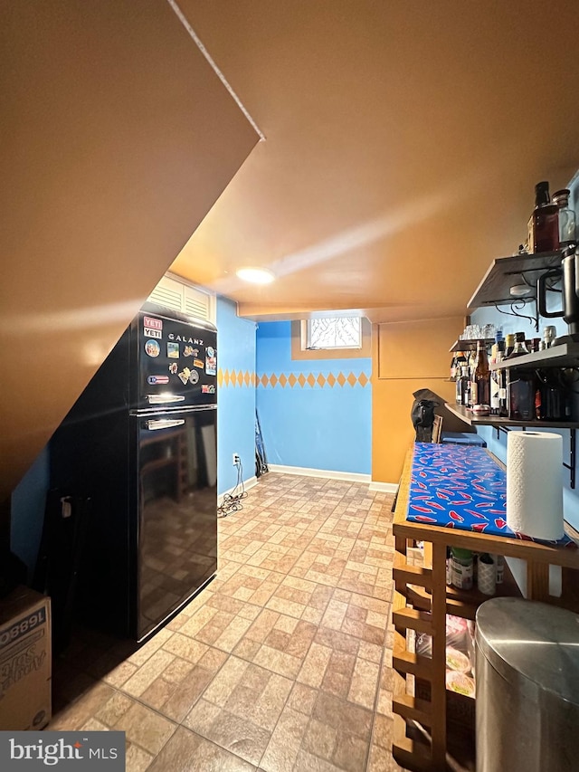 kitchen featuring black refrigerator