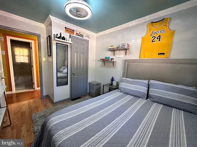 bedroom featuring wood-type flooring and ornamental molding