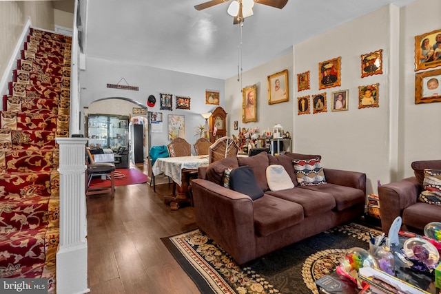 living room featuring wood-type flooring and ceiling fan