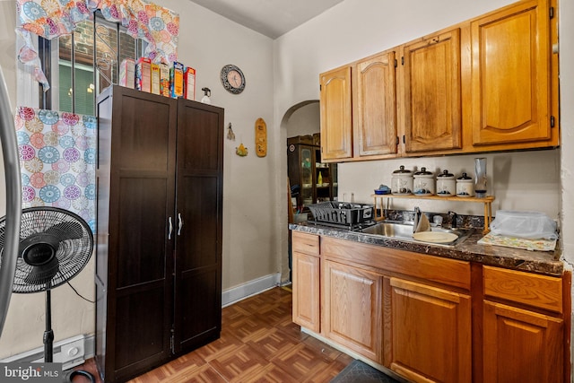 kitchen with sink and dark parquet floors