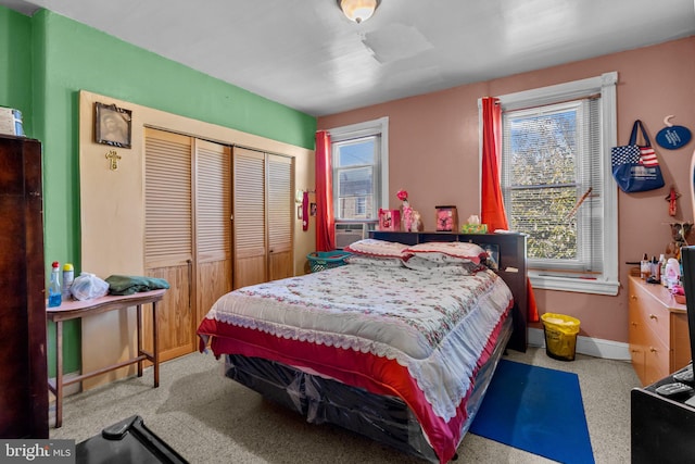 bedroom with multiple windows and a closet