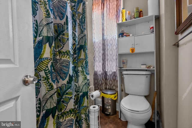 bathroom featuring tile patterned floors, toilet, and a shower with curtain